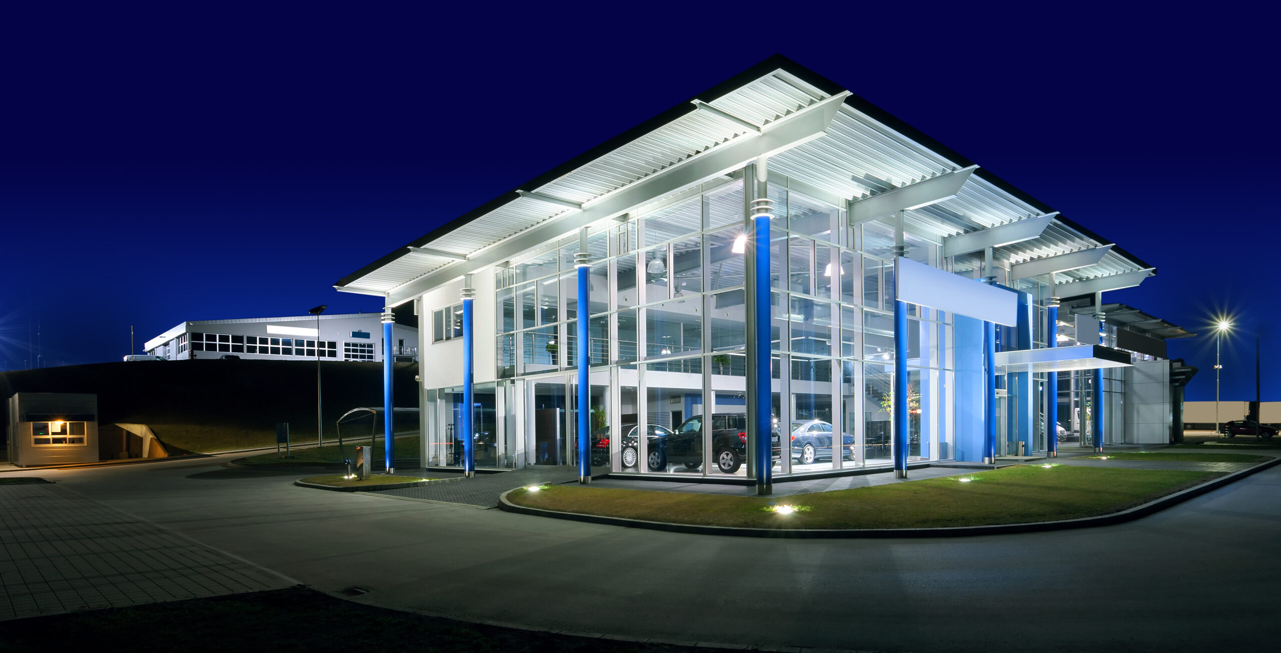 Exterior of a modern car salon, night scene.